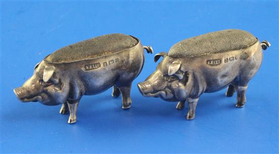 A near pair of Edwardian silver novelty pin cushions, each modelled as a pig, length approx. 2in.